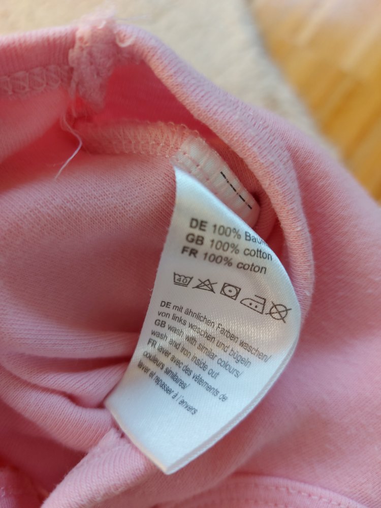 pinker Babystrampler mit Apfelmotiv, Gr. 50/56